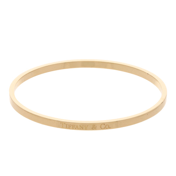 Pulsera de arillo lisa firma Tiffany & Co. en oro amarillo 18 kilates.