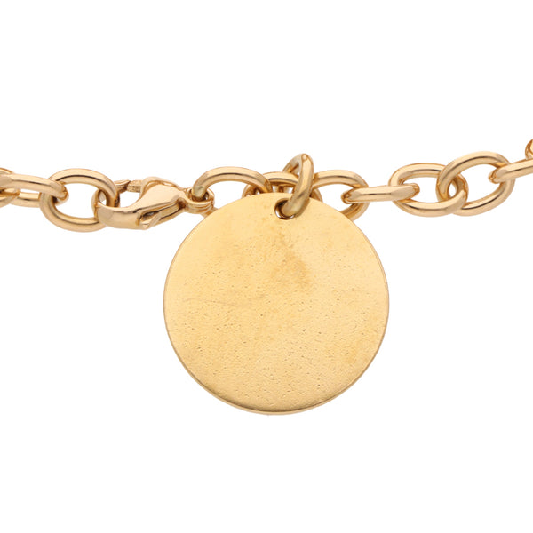 Pulsera eslabón cruzado con dije firma Tiffany & Co. en oro amarillo 18 kilates.