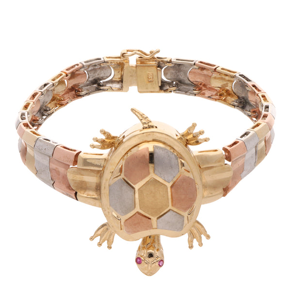 Pulsera eslabón articulado motivo tortuga en oro tres tonos 14 kilates.