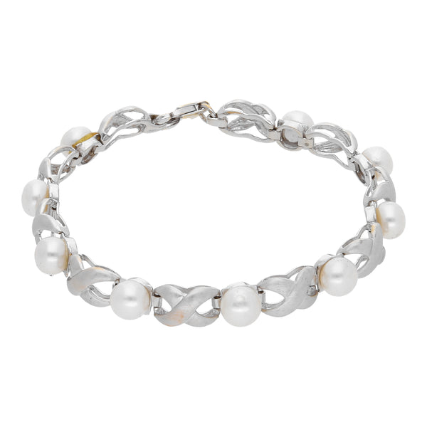 Pulsera estilizada con perlas en oro blanco 14 kilates.