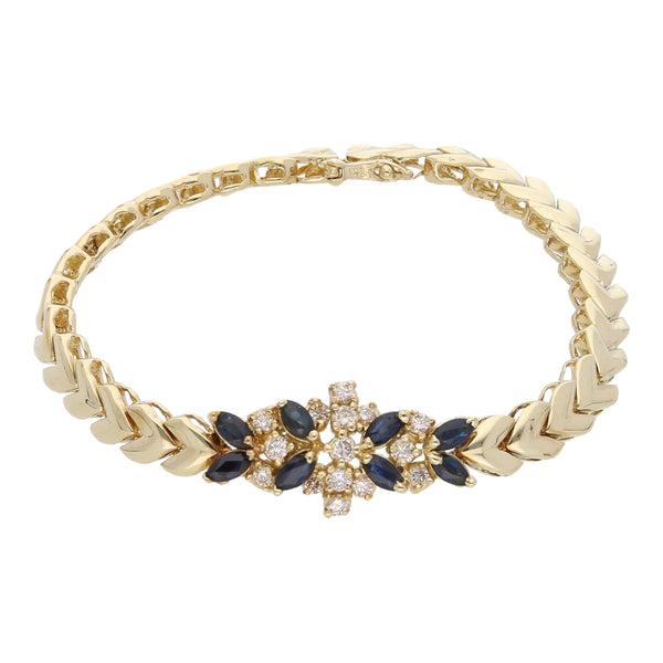 Pulsera estilizada con diamantes y zafiros en oro amarillo 14 kilates.