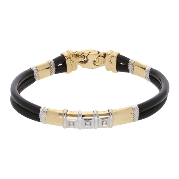 Pulsera diseño especial en caucho firma Zancan con diamantes y aplicaciones en oro dos tonos 18 kilates.