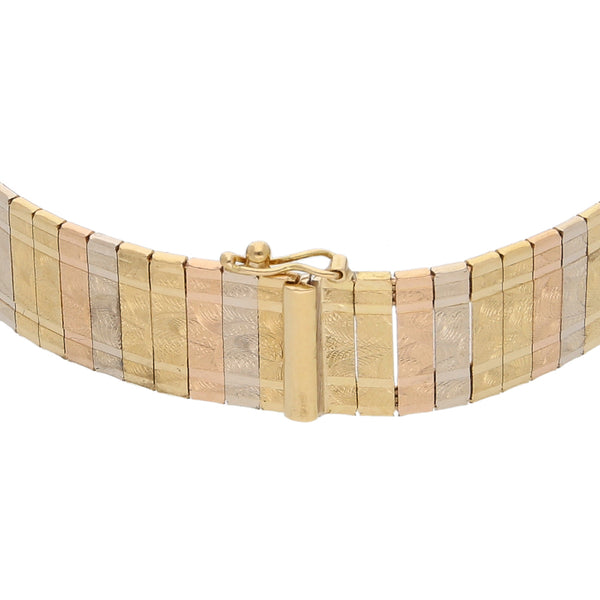 Pulsera eslabón planchado en oro tres tonos 18 kilates.