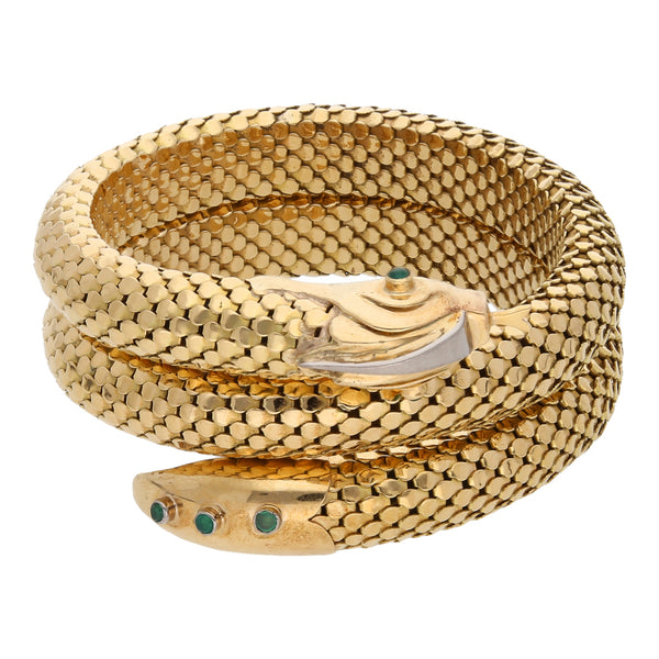 Pulsera con alma de acero estilizada motivo serpiente con esmeraldas en oro dos tonos 18 kilates.