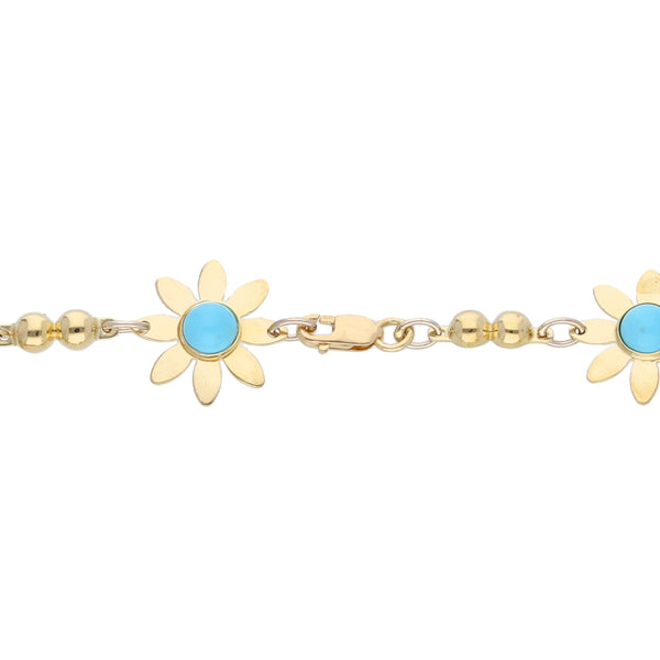 Pulsera eslabón combinado motivo floral con turquesas en oro amarillo 18 kilates.