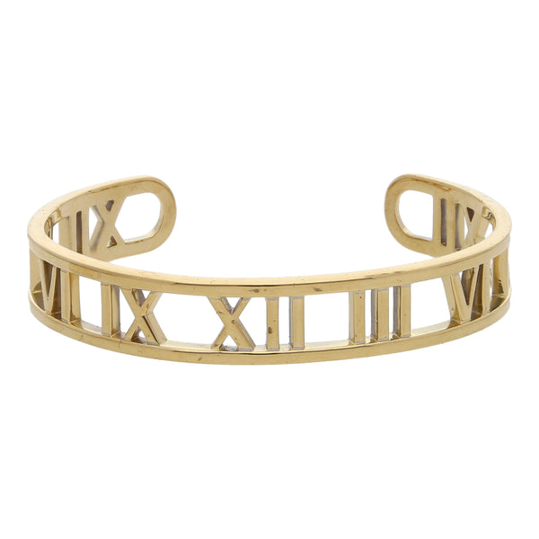 Pulsera abierta calada firma Tiffany & Co. colección Atlas motivo números romanos en oro amarillo 18 kilates.