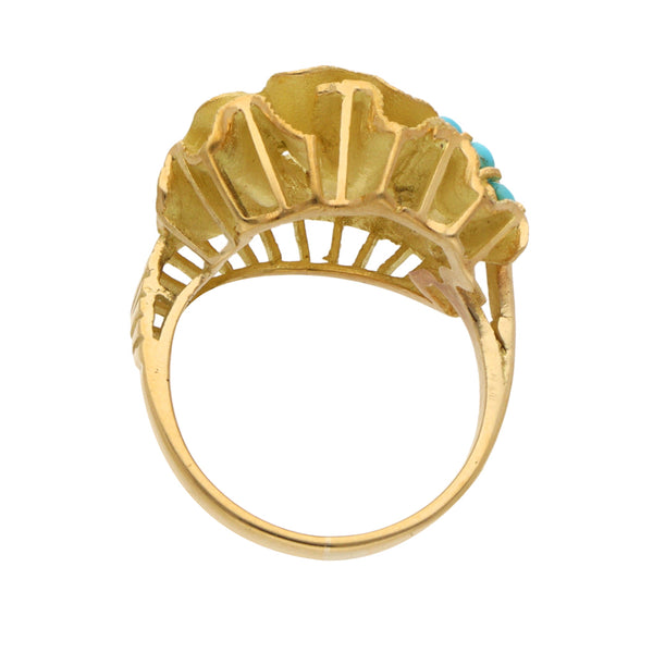 Anillo calado con turquesas en oro amarillo 18 kilates.