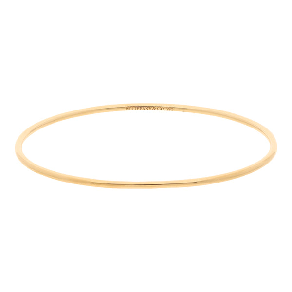 Pulsera de arillo lisa firma Tiffany & Co. en oro amarillo 18 kilates.