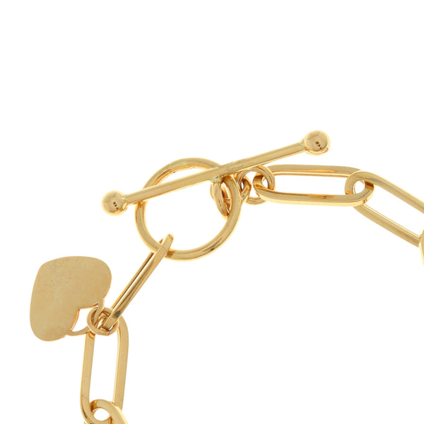 Pulsera eslabón cruzado con dije motivo corazón en oro amarillo 14 kilates.