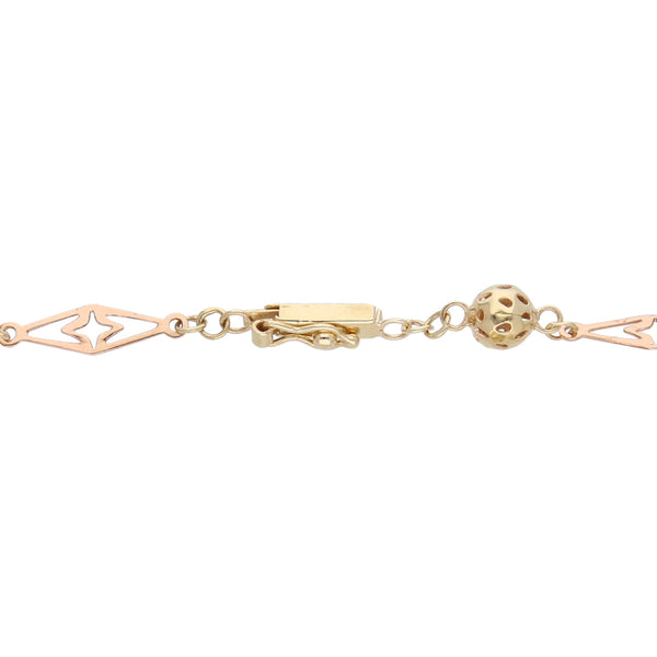 Pulsera eslabón combinado con esferas caladas en oro tres tonos 14 kilates.