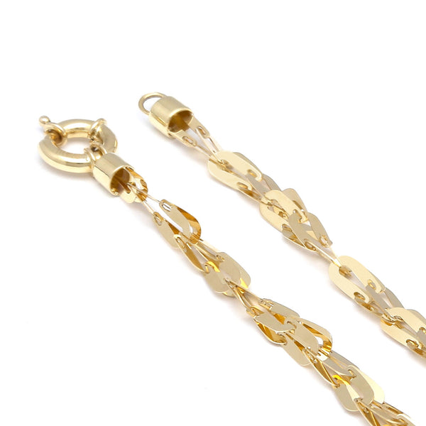 Pulsera eslabón cruzado laminado en oro amarillo 14 kilates.