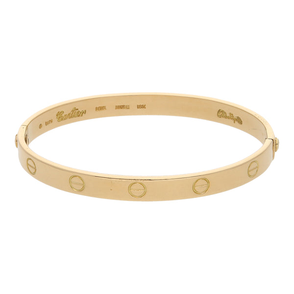 Brazalete ovalado articulado firma Cartier colección Love Aldo Cipullo en oro amarillo 18 kilates.