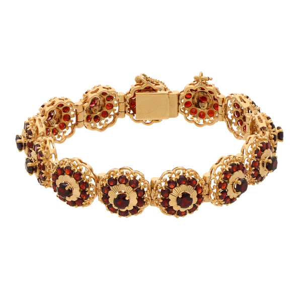 Pulsera eslabón articulado con granates en oro amarillo 18 kilates.