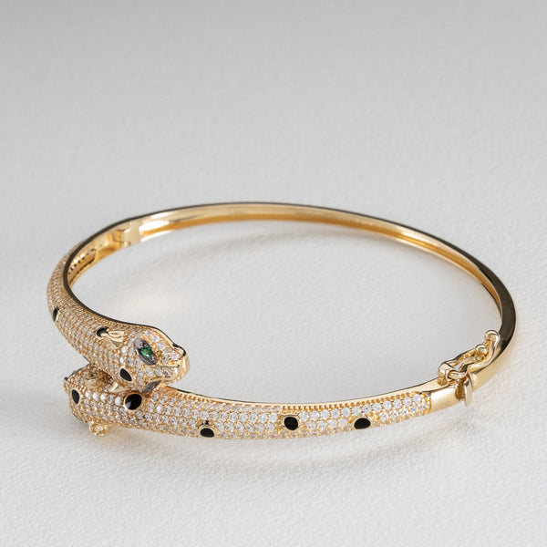 Pulsera de arillo ovalada articulada motivo felinos con circonias, sintéticos y esmalte en oro amarillo 14 kilates.