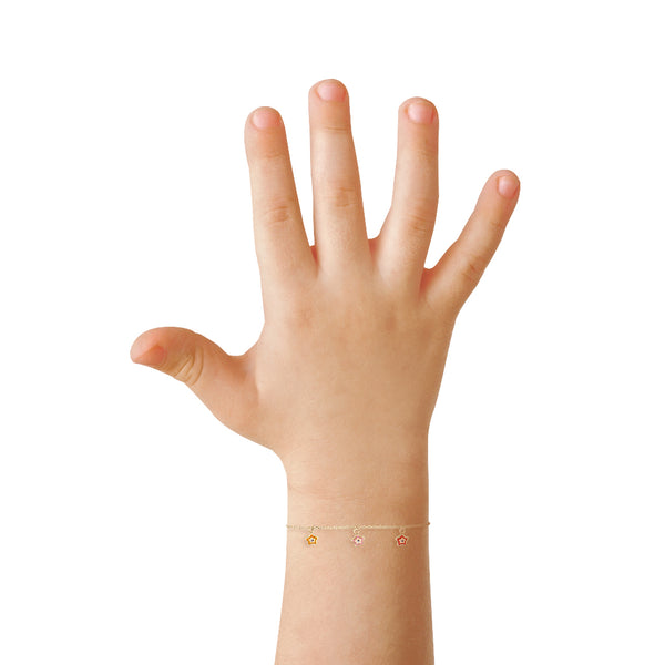 Pulsera infantil eslabón cruzado con cinco dijes motivo estrella y esmalte en oro amarillo 14 kilates.