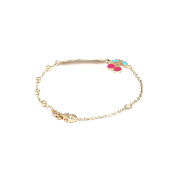 Pulsera infantil eslabón cruzado con esferas, placa y dije motivo cerezas con esmalte en oro amarillo 14 kilates.