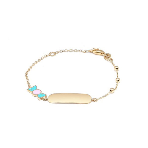 Pulsera infantil eslabón cruzado con esferas, placa y dije motivo dulce con esmalte en oro amarillo 14 kilates.