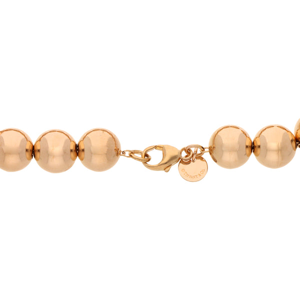 Pulsera eslabón cruzado doble con esferas firma Tiffany & Co. en oro rosa 18 kilates.