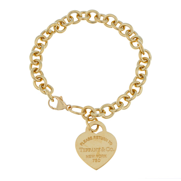 Pulsera eslabón cruzado con colgante motivo corazón firma Tiffany & Co en oro amarillo 18 kilates.