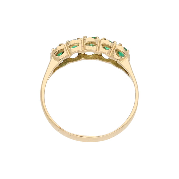 Anillo estilizado con esmeraldas en oro amarillo 18 kilates.