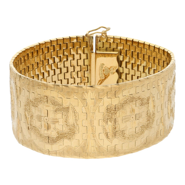 Brazalete eslabón articulado labrado en oro amarillo 18 kilates.