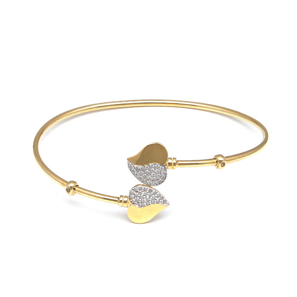 Pulsera ovalada abierta motivo corazones con circonias en oro amarillo 14 kilates.