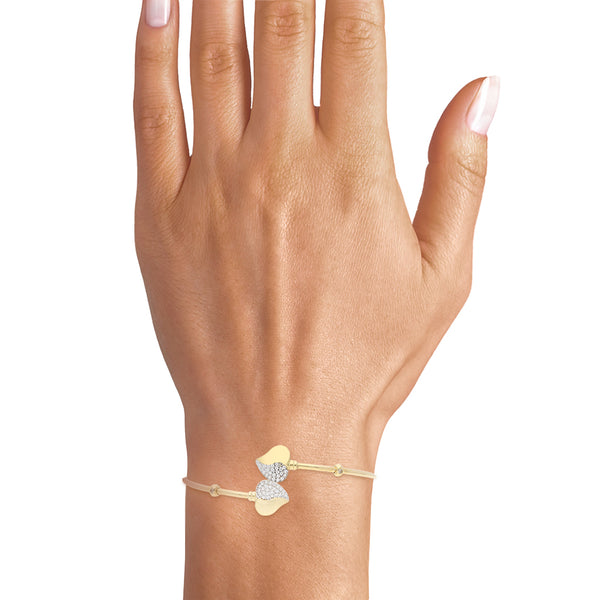 Pulsera ovalada abierta motivo corazones con circonias en oro amarillo 14 kilates.