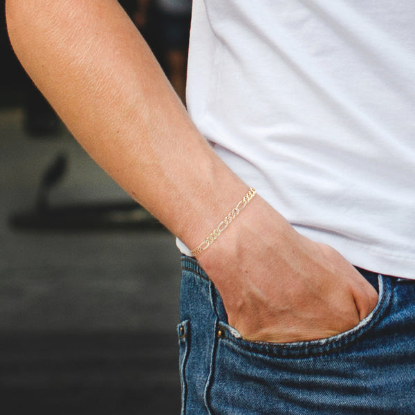 Pulsera de tres eslabones por uno platinado en oro tres tonos 14 kilates.