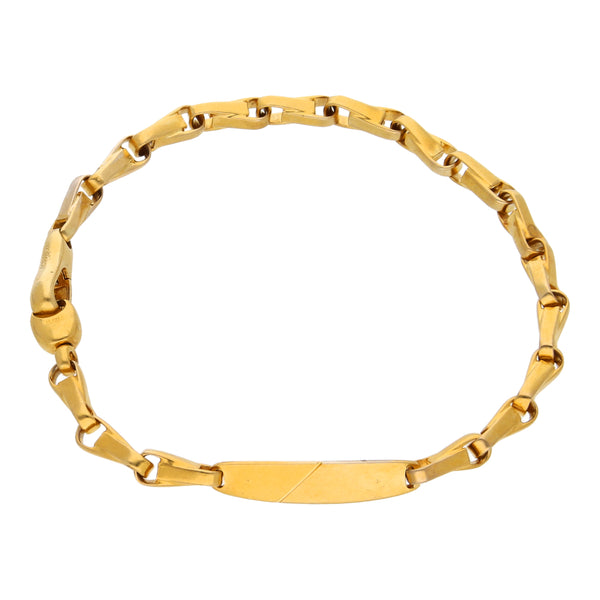 Pulsera eslabón cruzado con aplicación de placa en oro amarillo 18 kilates.