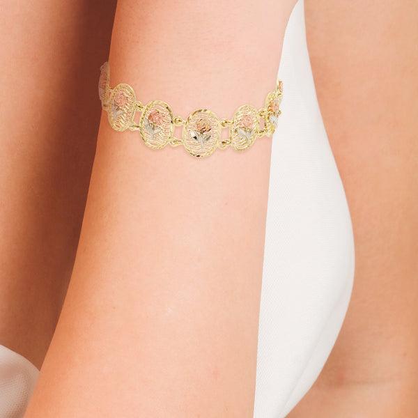 Pulsera eslabón articulado motivo floral en oro tres tonos 14 kilates.