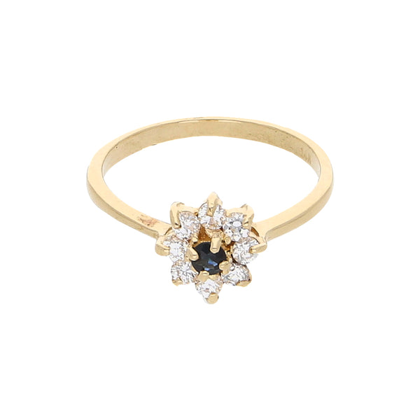 Anillo estilizado motivo floral con circonias y zafiro en oro amarillo 14 kilates.