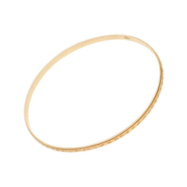 Pulsera de arillo ovalada labrada en oro amarillo 18 kilates.