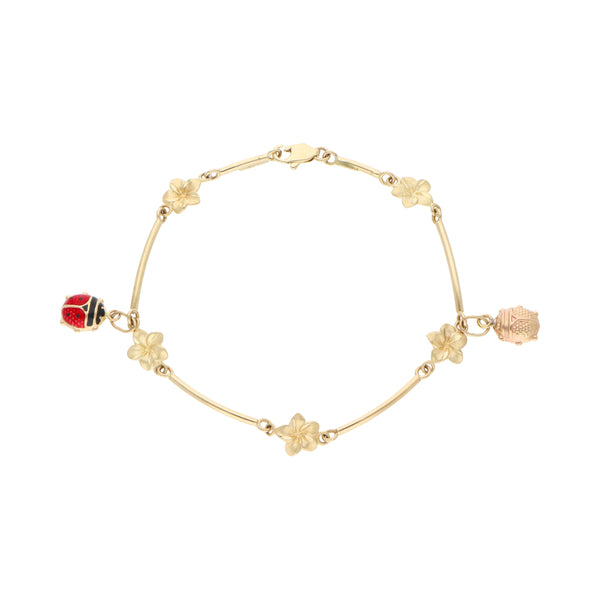 Pulsera eslabón combinado con colgantes motivo catarinas, floral y esmalte en oro amarillo 14 kilates.