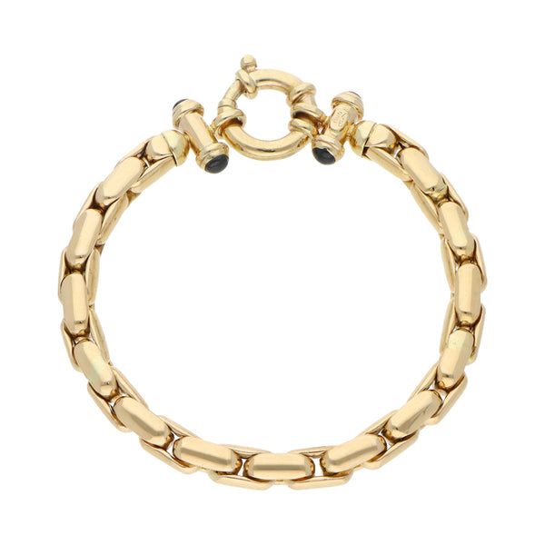 Pulsera eslabón cruzado con zafiros en oro amarillo 14 kilates.