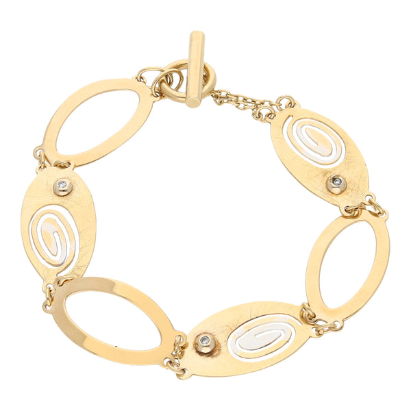 Pulsera eslabón combinado con circonias en oro amarillo 14 kilates.