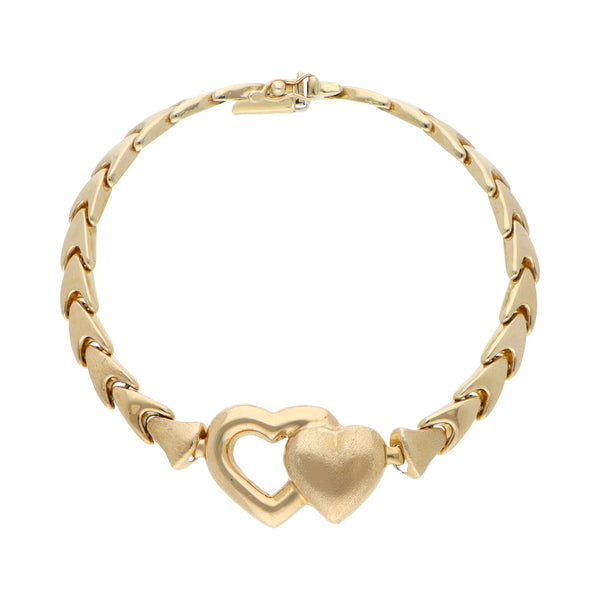 Pulsera eslabón articulado con aplicación motivo corazones en oro amarillo 14 kilates.