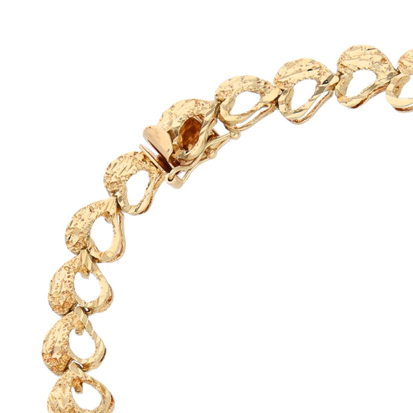 Pulsera eslabón articulado motivo corazones en oro amarillo 14 kilates.