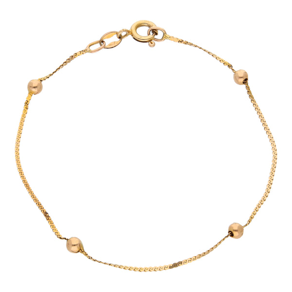 Pulsera eslabón planchado con esferas lisas en oro amarillo 14 kilates.