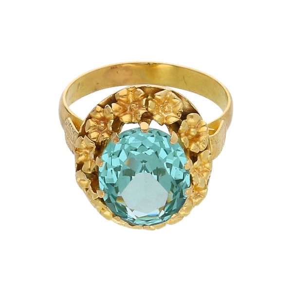 Anillo calado motivo floral con sintético en oro amarillo 14 kilates.