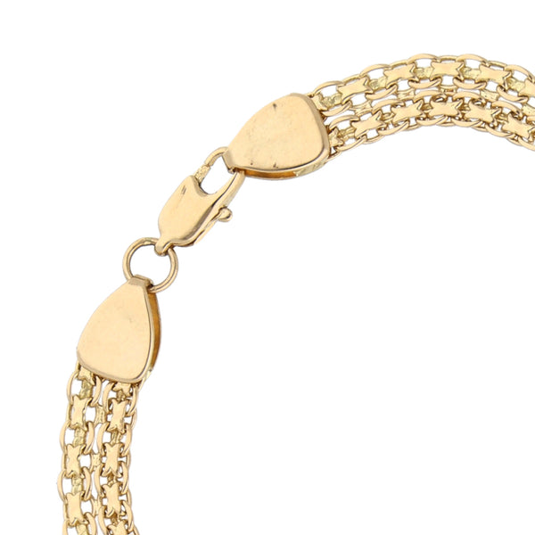 Pulsera eslabón palmeado con aplicaciones en oro amarillo 14 kilates.