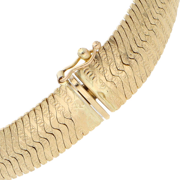 Pulsera eslabón planchado en oro amarillo 14 kilates.