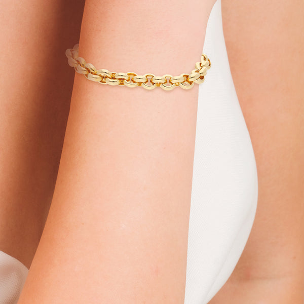 Pulsera eslabón cruzado con aplicaciones, sintéticos y colgante en oro amarillo 14 kilates.