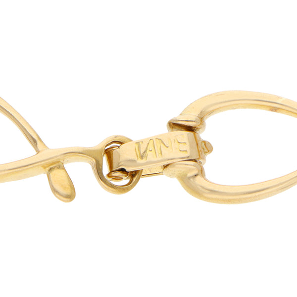 Pulsera eslabón cruzado firma Tane en oro amarillo 18 kilates.