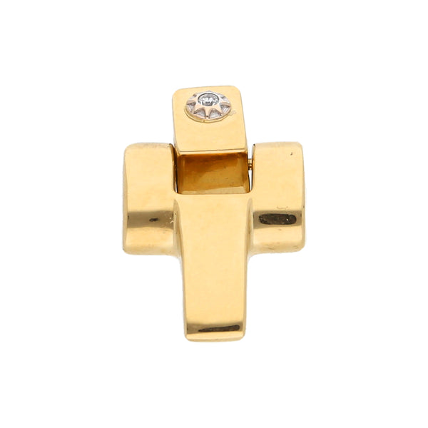 Cruz articulada con diamante en oro amarillo 18 kilates.