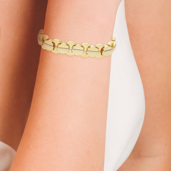 Pulsera eslabón articulado combinado en oro dos tonos 18 kilates.