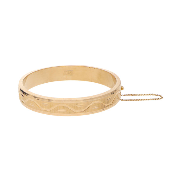 Pulsera de arillo articulada labrada en oro amarillo 18 kilates.
