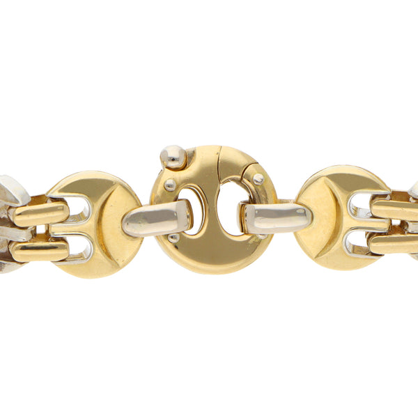 Pulsera eslabón articulado combinado con aplicación en oro dos tonos 18 kilates.