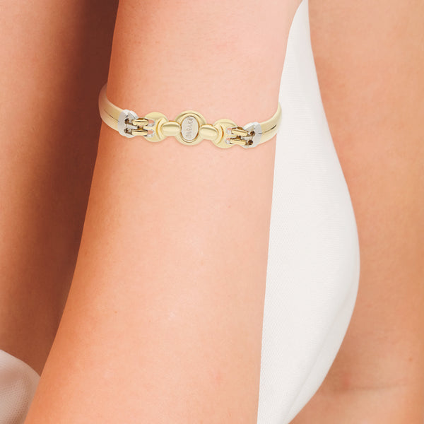 Pulsera eslabón articulado combinado con aplicación en oro dos tonos 18 kilates.
