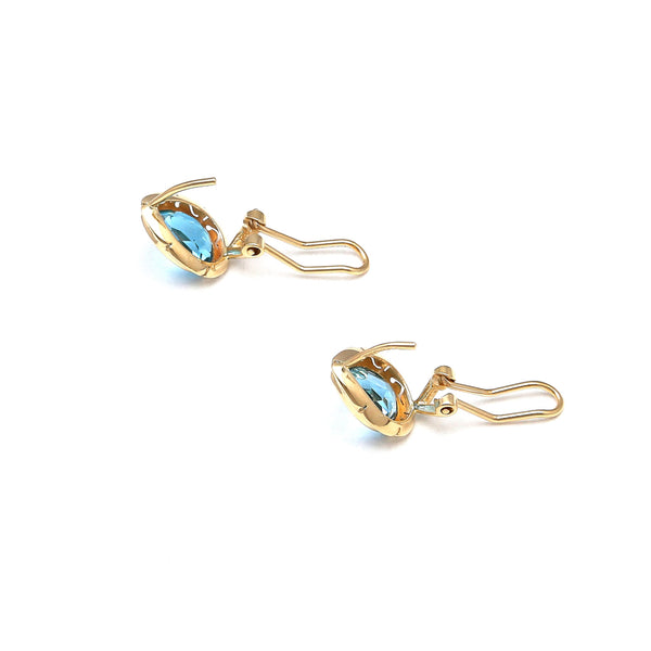 Juego de anillo y aretes calados con topacios azules en oro amarillo 14 kilates.