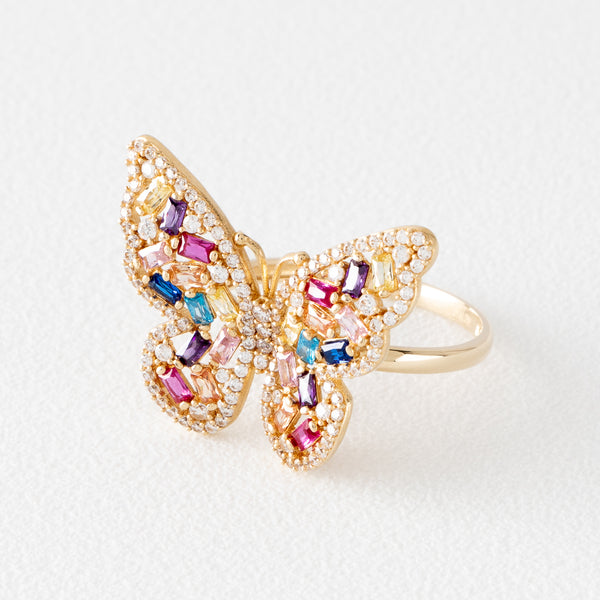 Anillo estilizado motivo mariposa con sintéticos en oro amarillo 14 kilates.